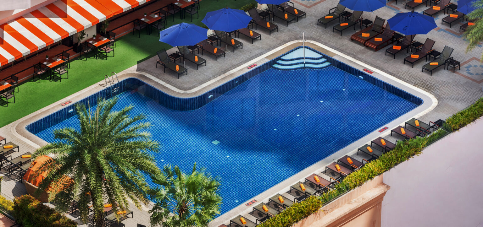 Outdoor swimming pool with Sukhumvit city view at Rembrandt Hotel Bangkok