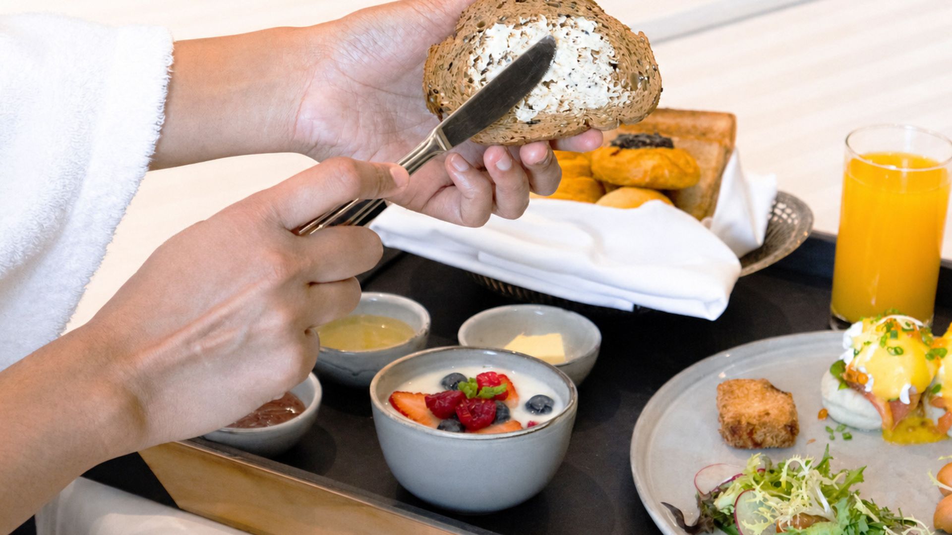 Breakfast tray with fresh bread and juice at Bangkok hotel